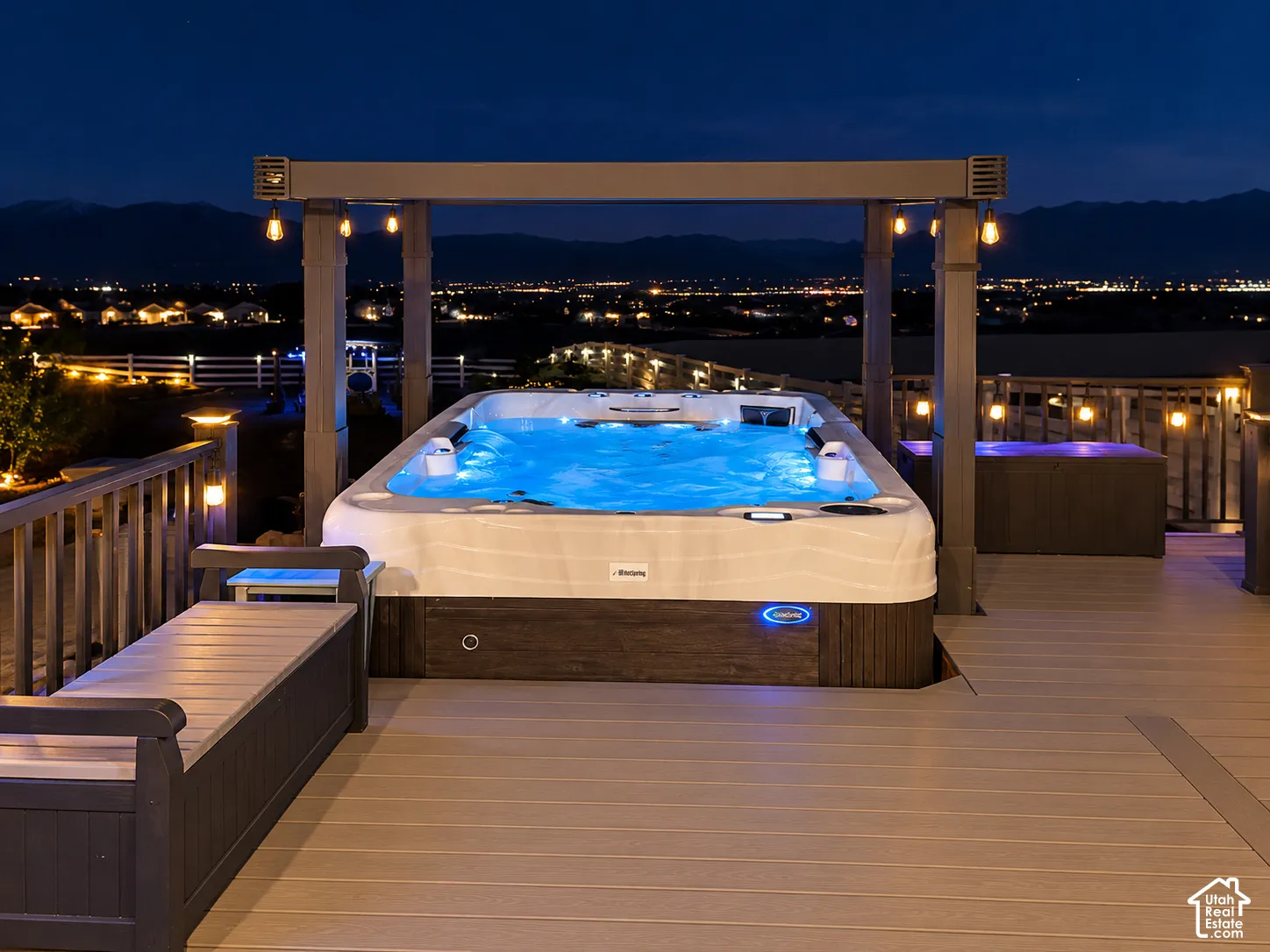 Composite deck featuring a built-in swim spa, structural pergola with integrated lighting, and perimeter railing
