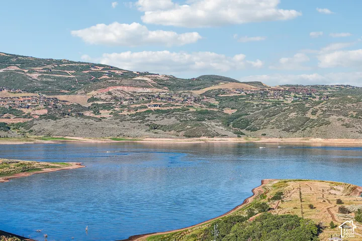Expansive water frontage featuring a reservoir, rugged hillside terrain, and natural landscape