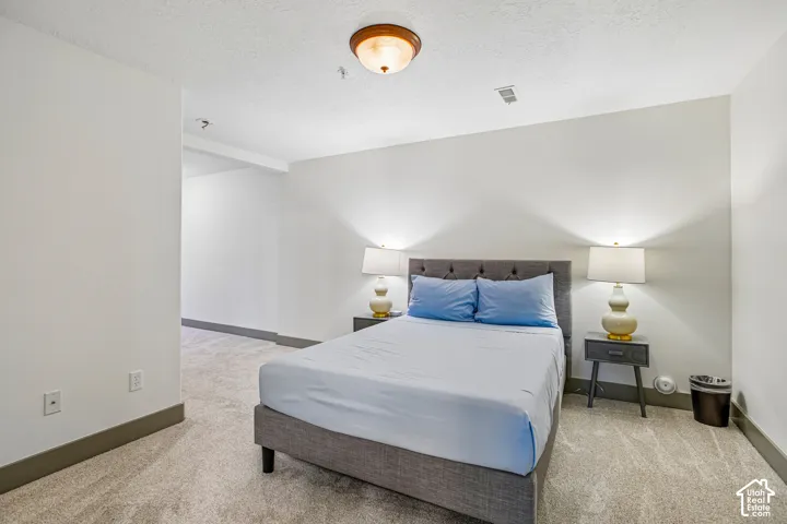 Interior space featuring wall-to-wall carpeting, neutral wall paint, and a circular flush-mount ceiling fixture