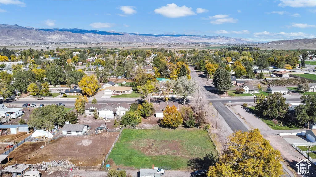 Cleared residential lot featuring expansive mountain terrain and mature trees