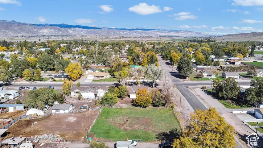 Cleared residential lot featuring expansive mountain terrain and mature trees