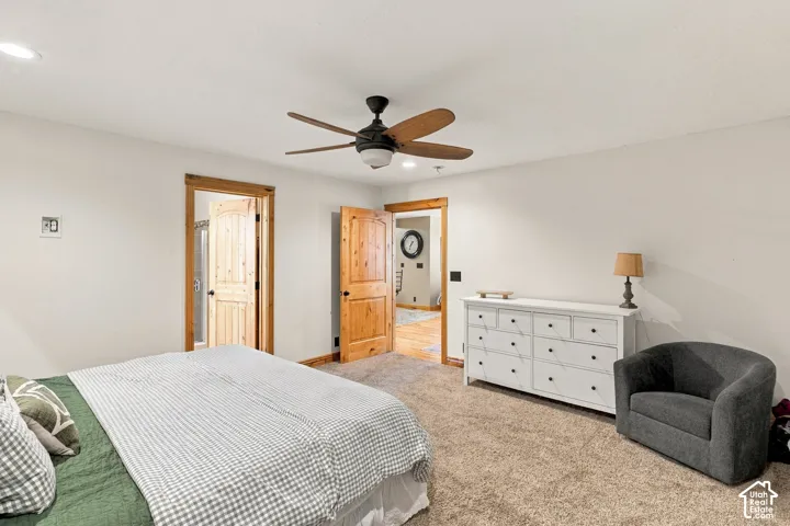 Neutral-toned room featuring recessed lighting, a five-blade ceiling fan, and natural wood-finish interior door trim