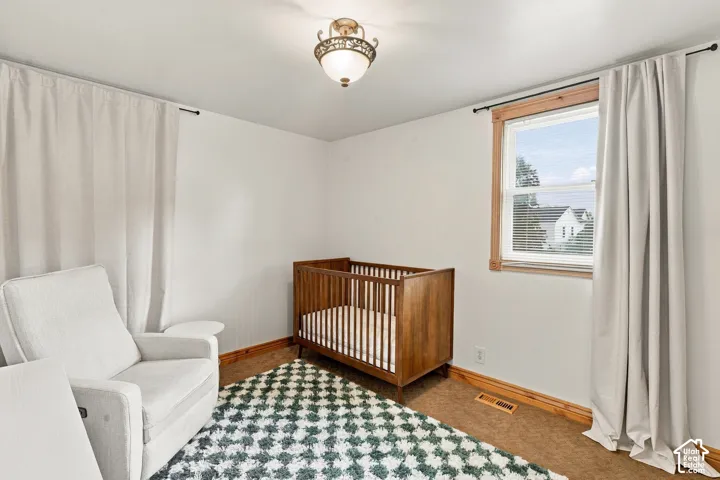 Neutral wall tones, wood-trimmed window, and decorative flush-mount ceiling lighting