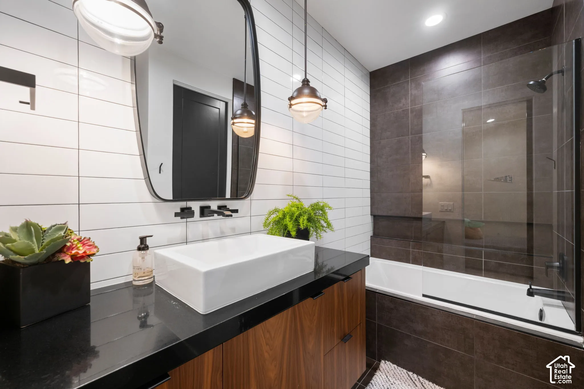Vanity featuring a rectangular vessel sink, polished stone countertop, and wood-finish cabinetry