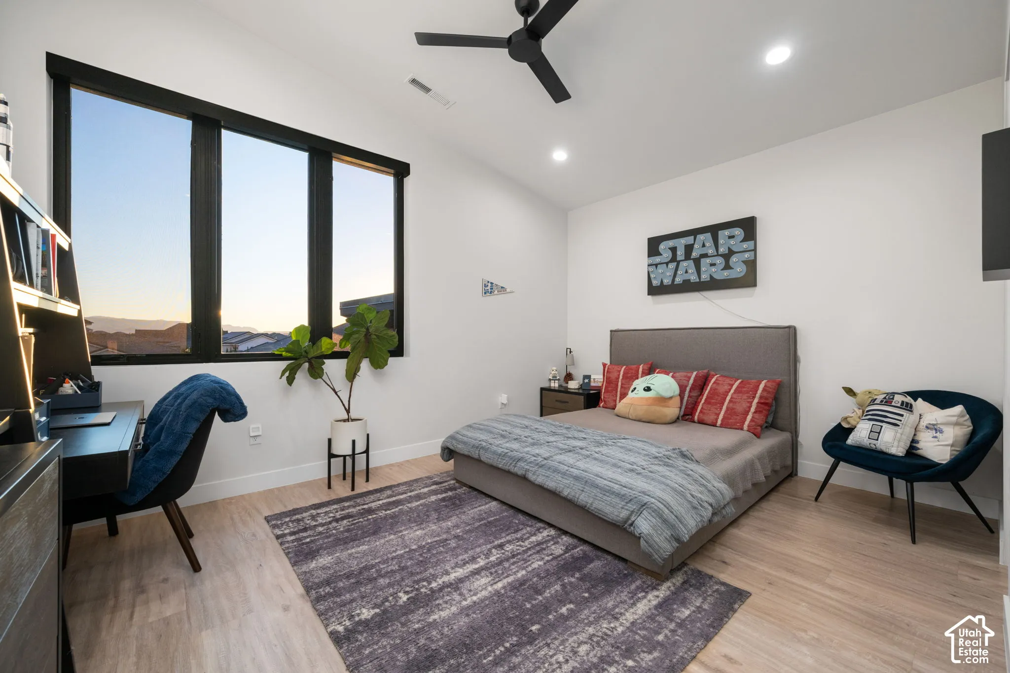 Large windows with black frames, wood-finish flooring, recessed lighting, and a modern ceiling fan