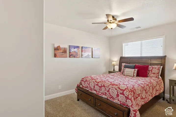 Neutral-toned walls with ceiling-mounted fan and horizontal window blinds