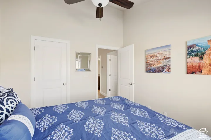 Vaulted ceilings, multi-panel interior doors, and a ceiling fan with integrated lighting