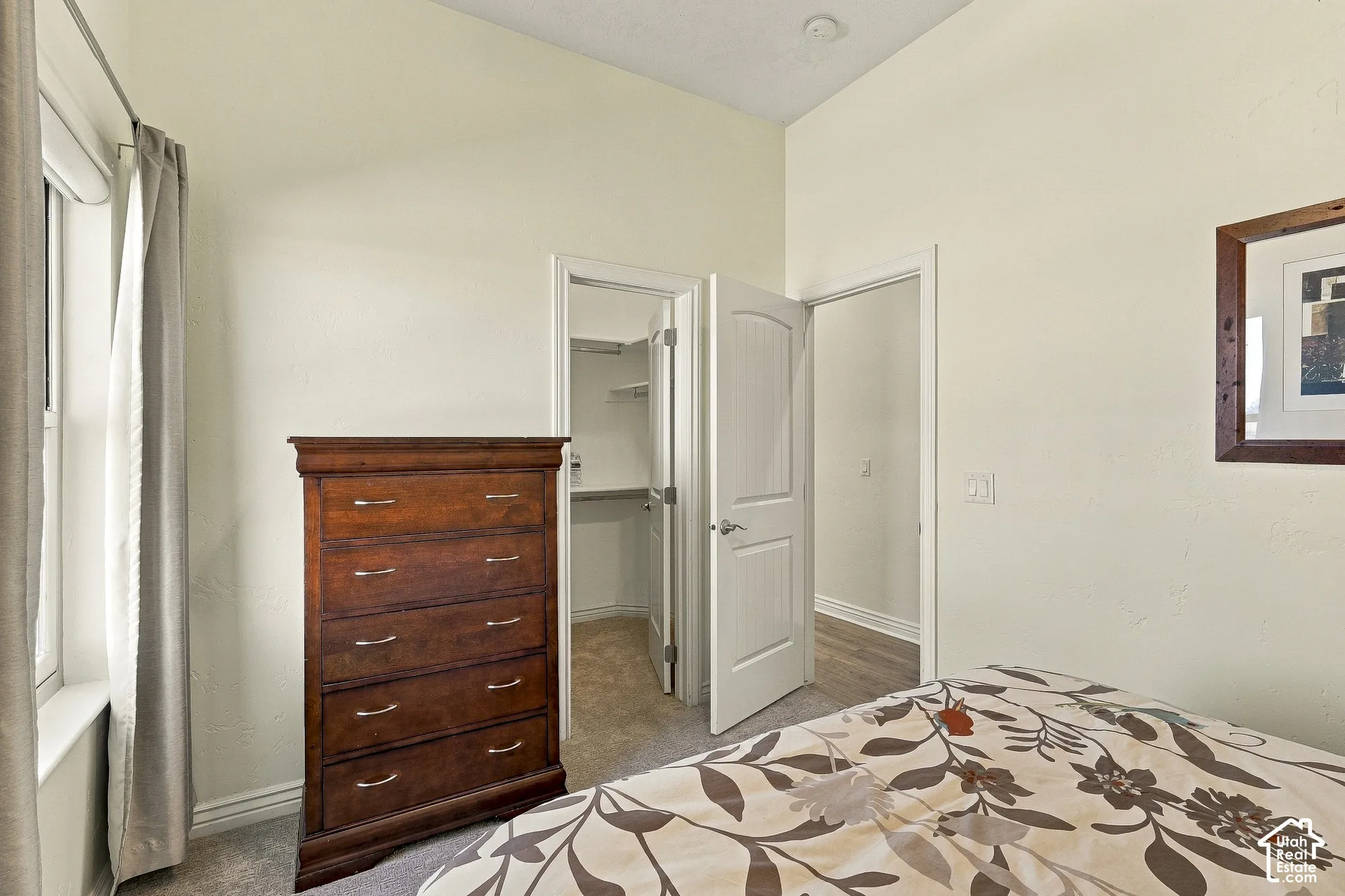 High ceilings, neutral wall tones, two-panel interior doors, and walk-in storage featuring wire shelving