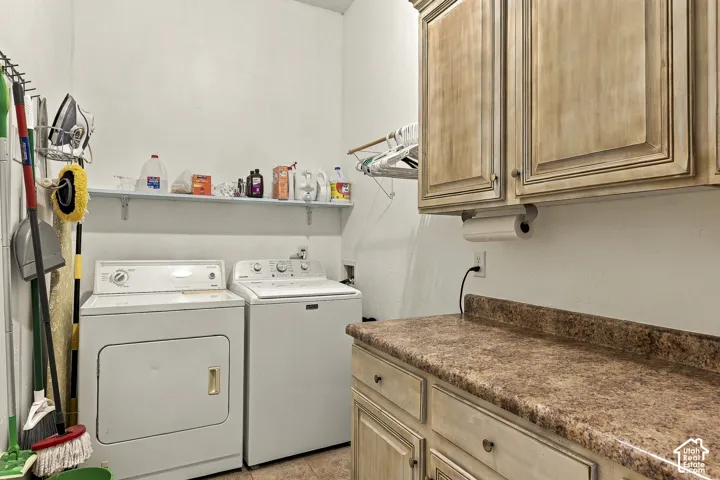 Laundry area featuring stained wood-finish cabinetry, stone-texture laminate countertop, and a wall-mounted storage shelf