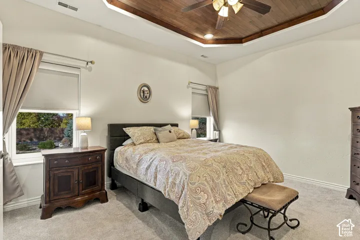 Tray ceiling featuring wood-plank detailing, recessed lighting, and a central ceiling fan