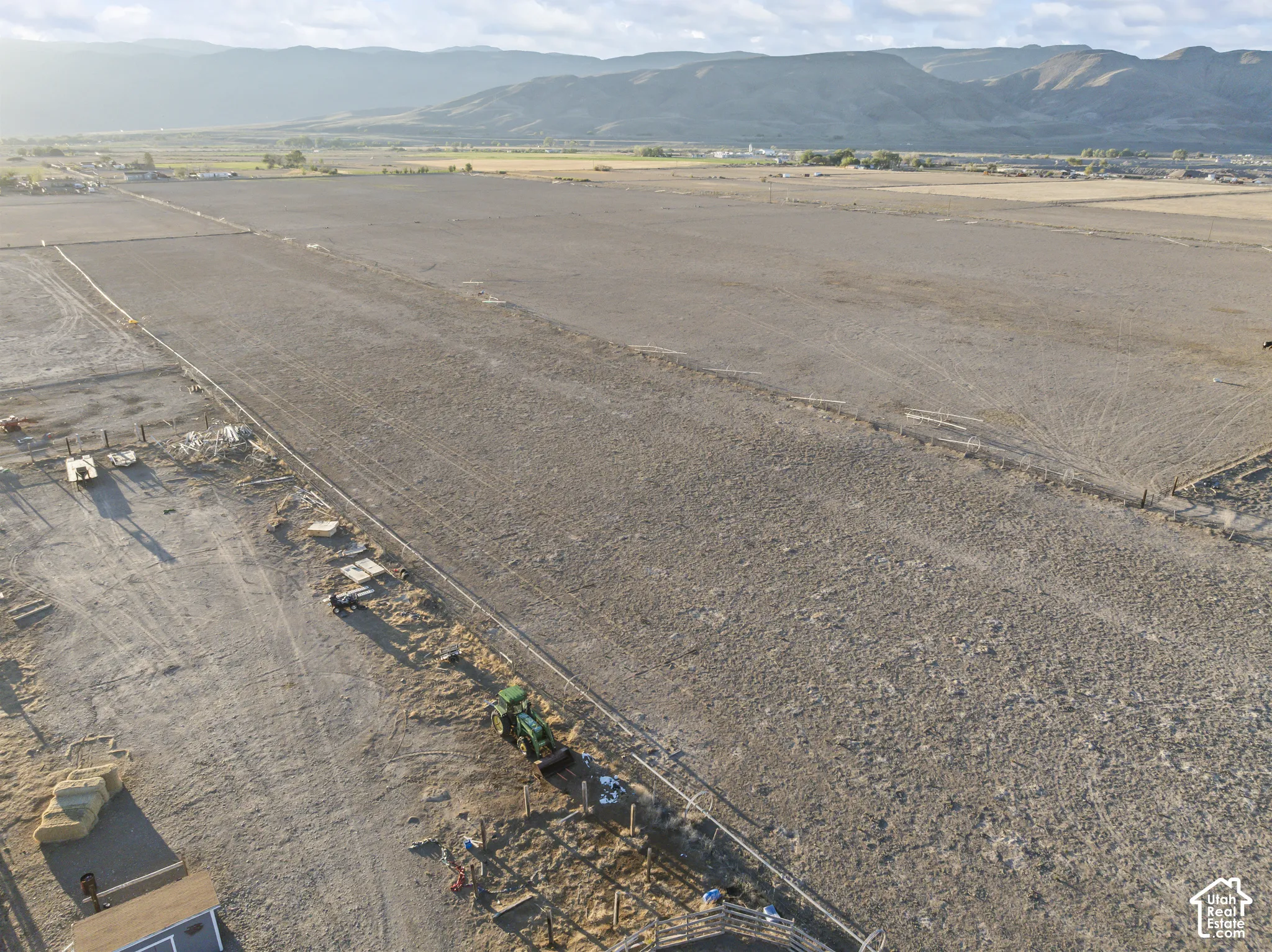 Expansive acreage featuring level topography, post-and-rail fencing, and mountain scenery