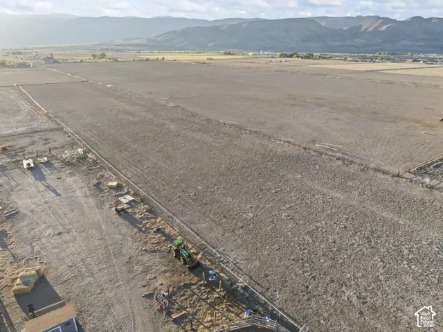 Expansive acreage featuring level topography, post-and-rail fencing, and mountain scenery