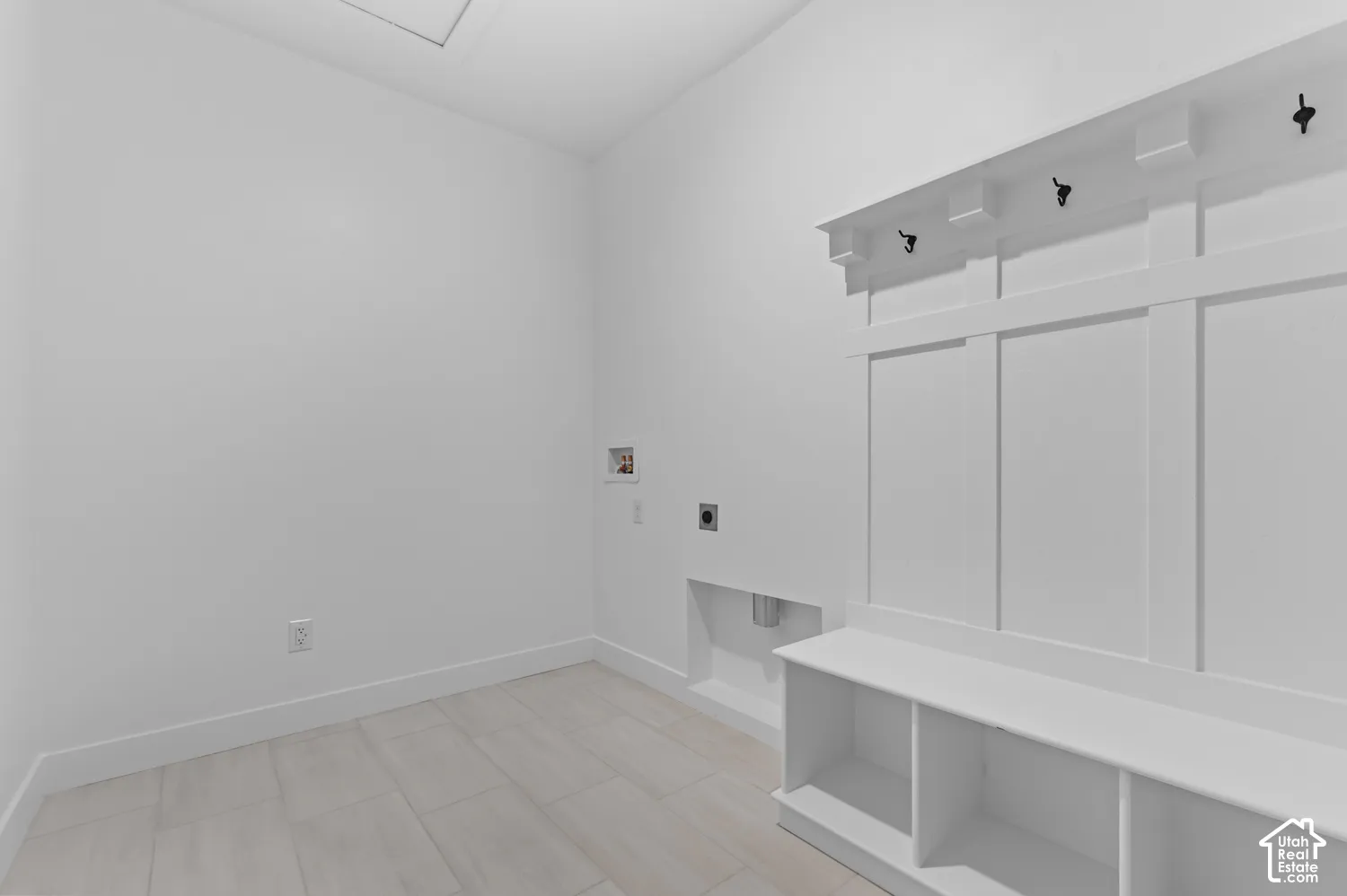 Built-in wall-mounted cabinetry featuring recessed panel detailing, open cubby storage, and matte black hardware