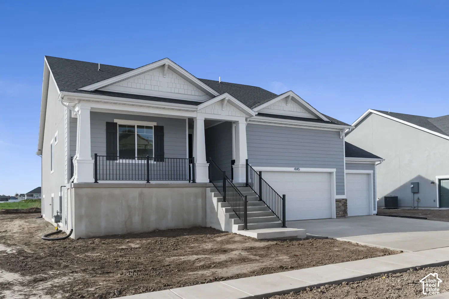 Craftsman-inspired exterior featuring horizontal siding, decorative gable accents, a covered front porch with squared columns, black metal railings, and a three-car garage