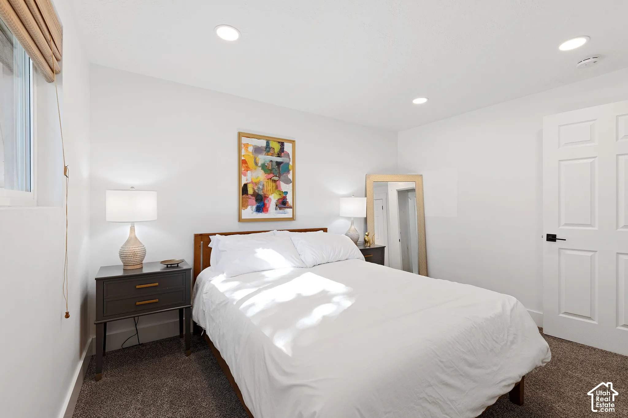 Neutral-toned room featuring recessed lighting, high-pile carpeting, and a white six-panel door with matte black hardware
