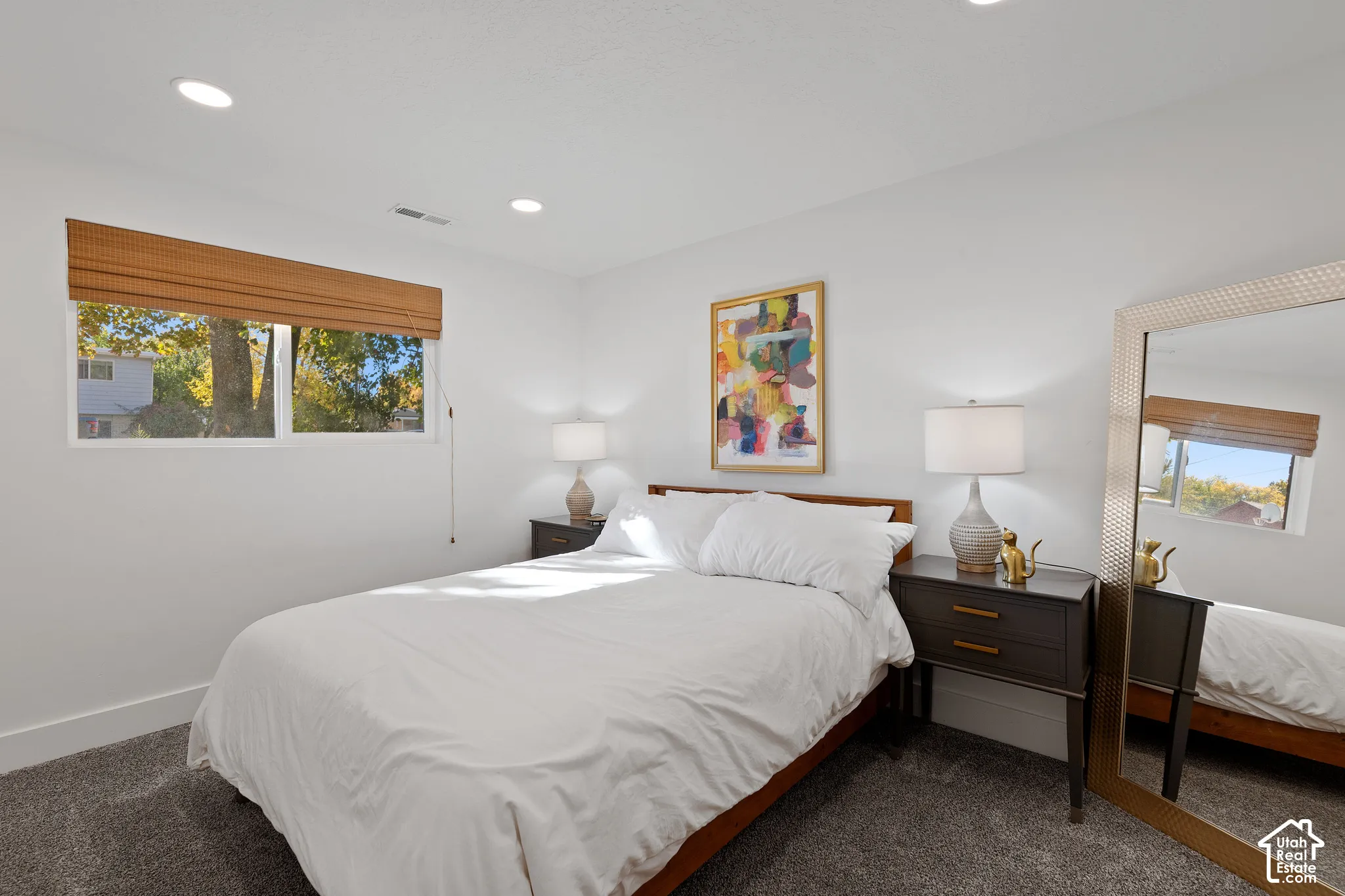Neutral interior featuring recessed lighting, plush wall-to-wall carpeting, and large windows with integrated woven-wood shades