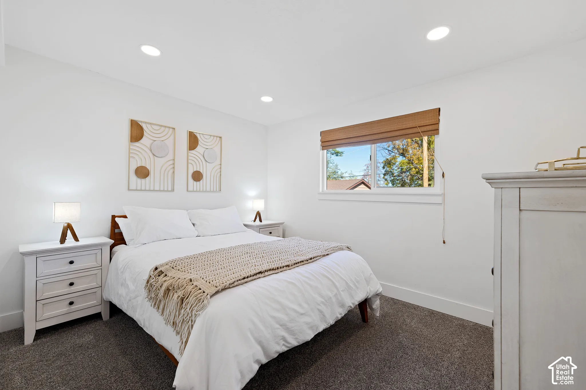 Neutral wall tones, recessed lighting, carpeted flooring, and window featuring an integrated textured shade