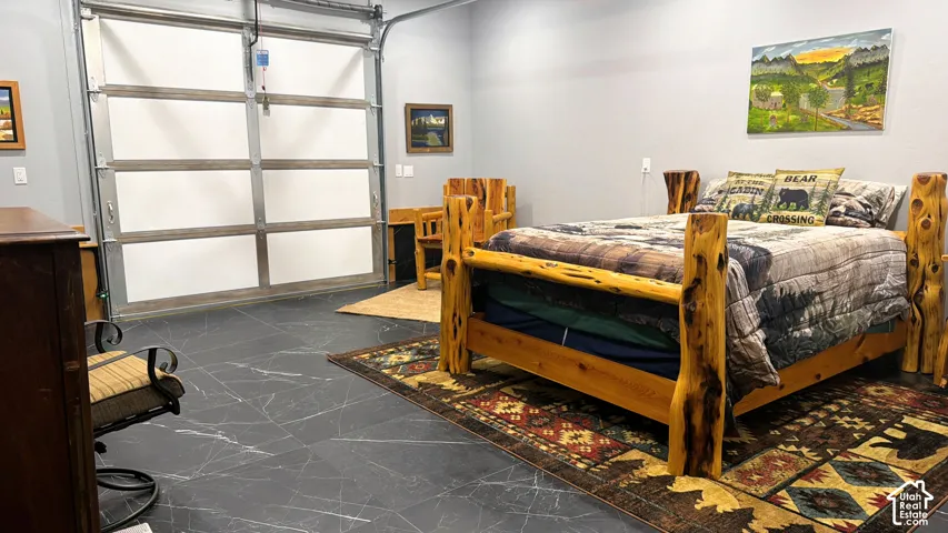 Large-format dark tile flooring and a multi-panel glass garage door