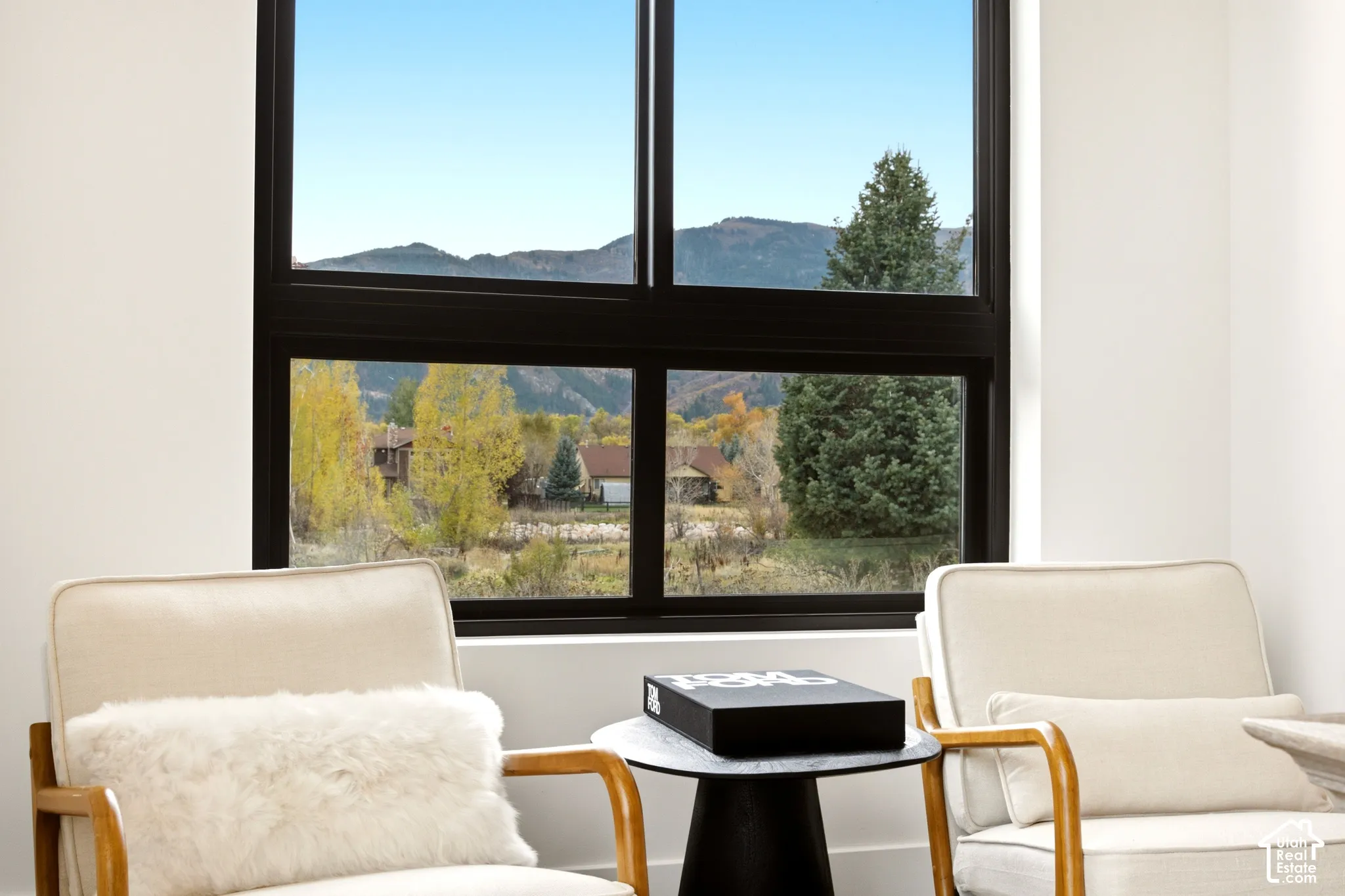 Office sitting area with Mountain Views framed by large black windows