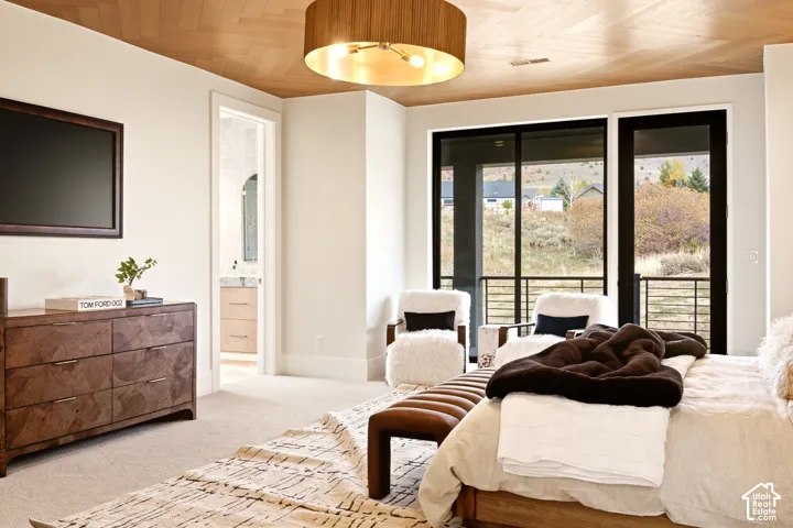 Herringbone engineered wood ceiling, drum pendant light, floor-to-ceiling black windows and full view glass door walking out onto a private balcony