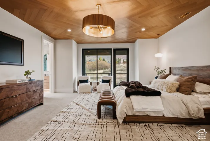 Primary Bedroom showcasing Herringbone-patterned Engineered hardwood ceiling, drum pendant lighting, recessed lighting, and expansive glass framing mountain views leading to the private balcony.