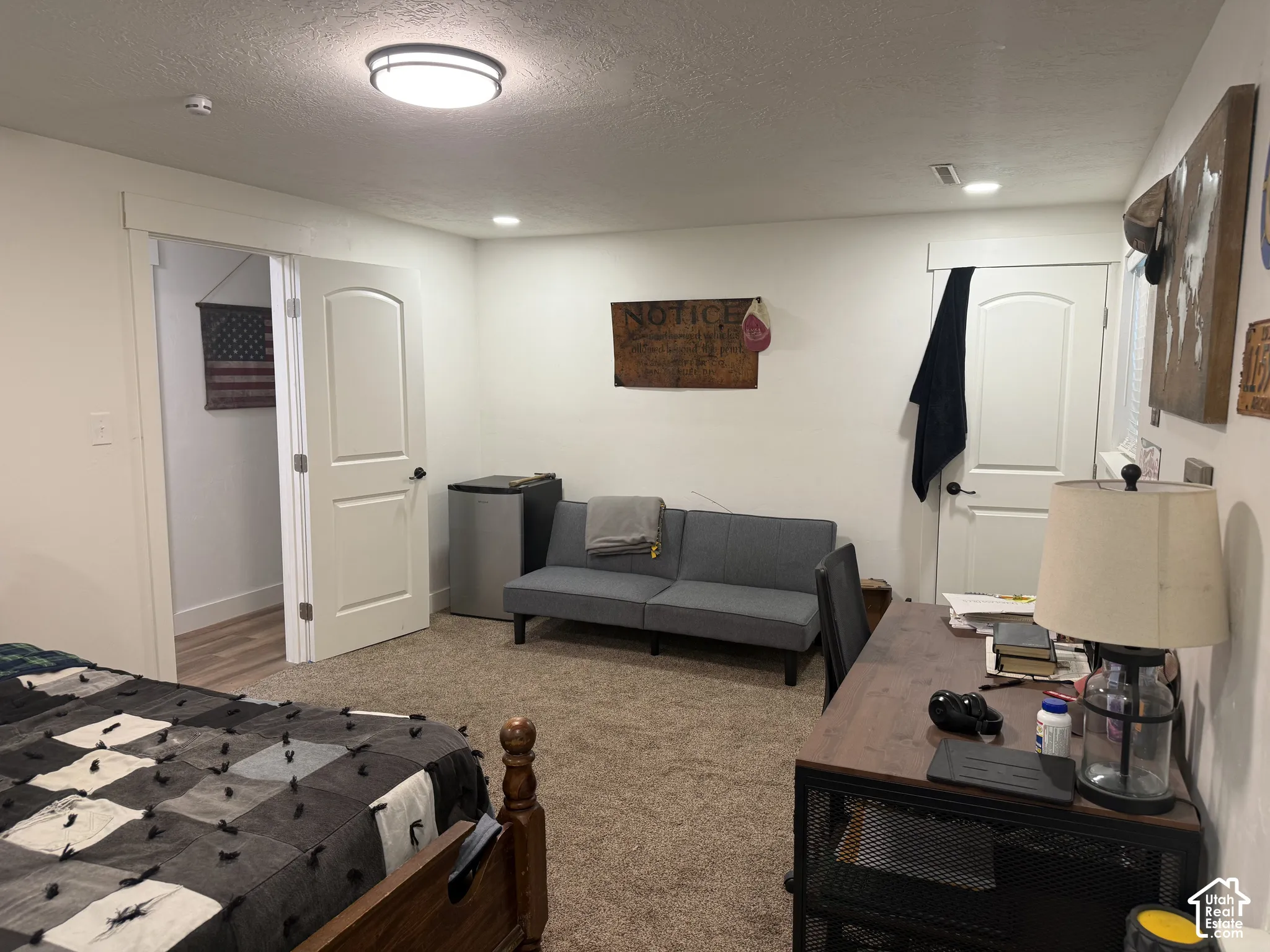 Neutral-toned room featuring neutral carpeting, arched-panel interior doors, and overhead flush-mount lighting