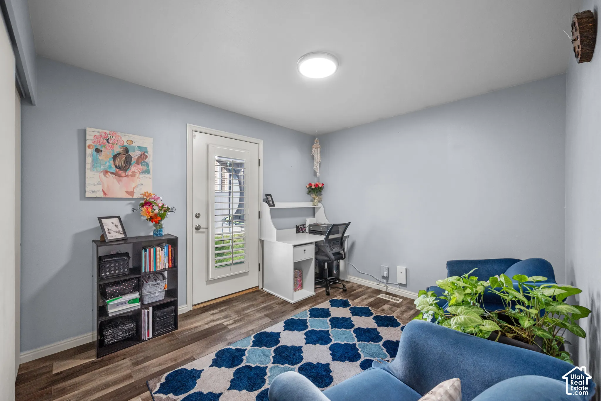 Room featuring wood-finish flooring, a flush-mount ceiling light fixture, and an exterior door with an inset glass panel