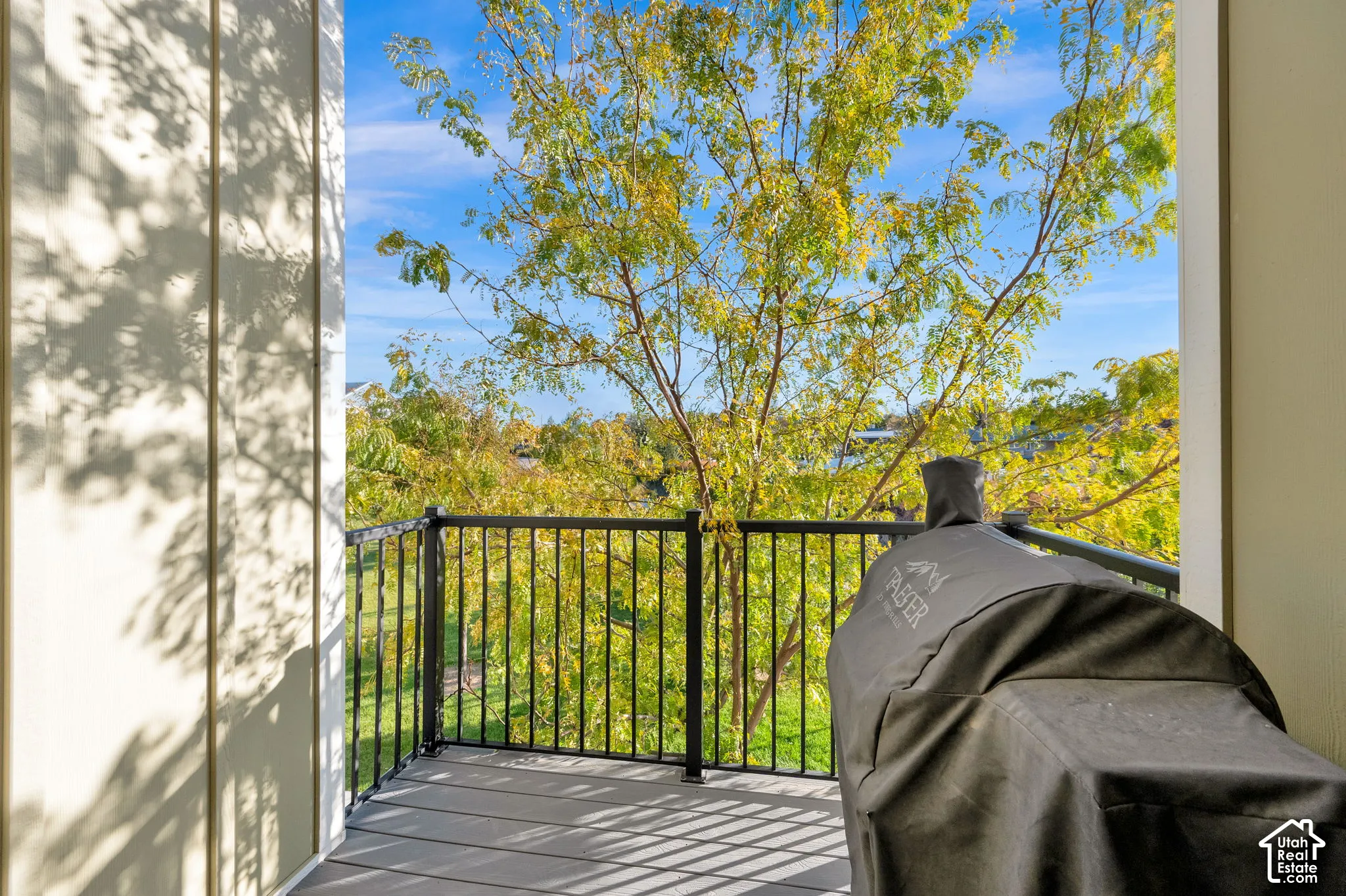 Private balcony featuring composite decking and a black metal railing