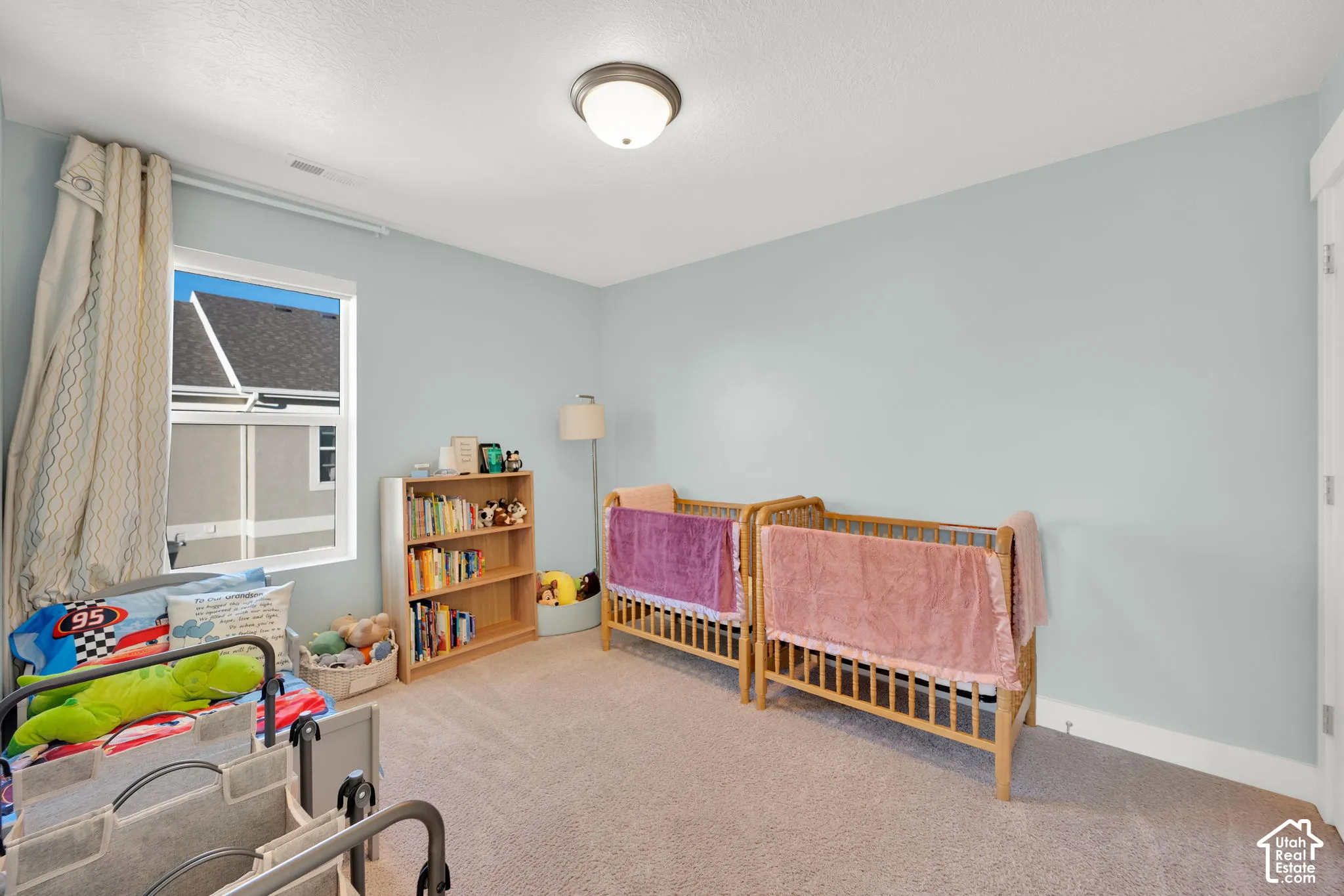 Neutral wall palette, wall-to-wall carpeting, and a single-pane window with white trim