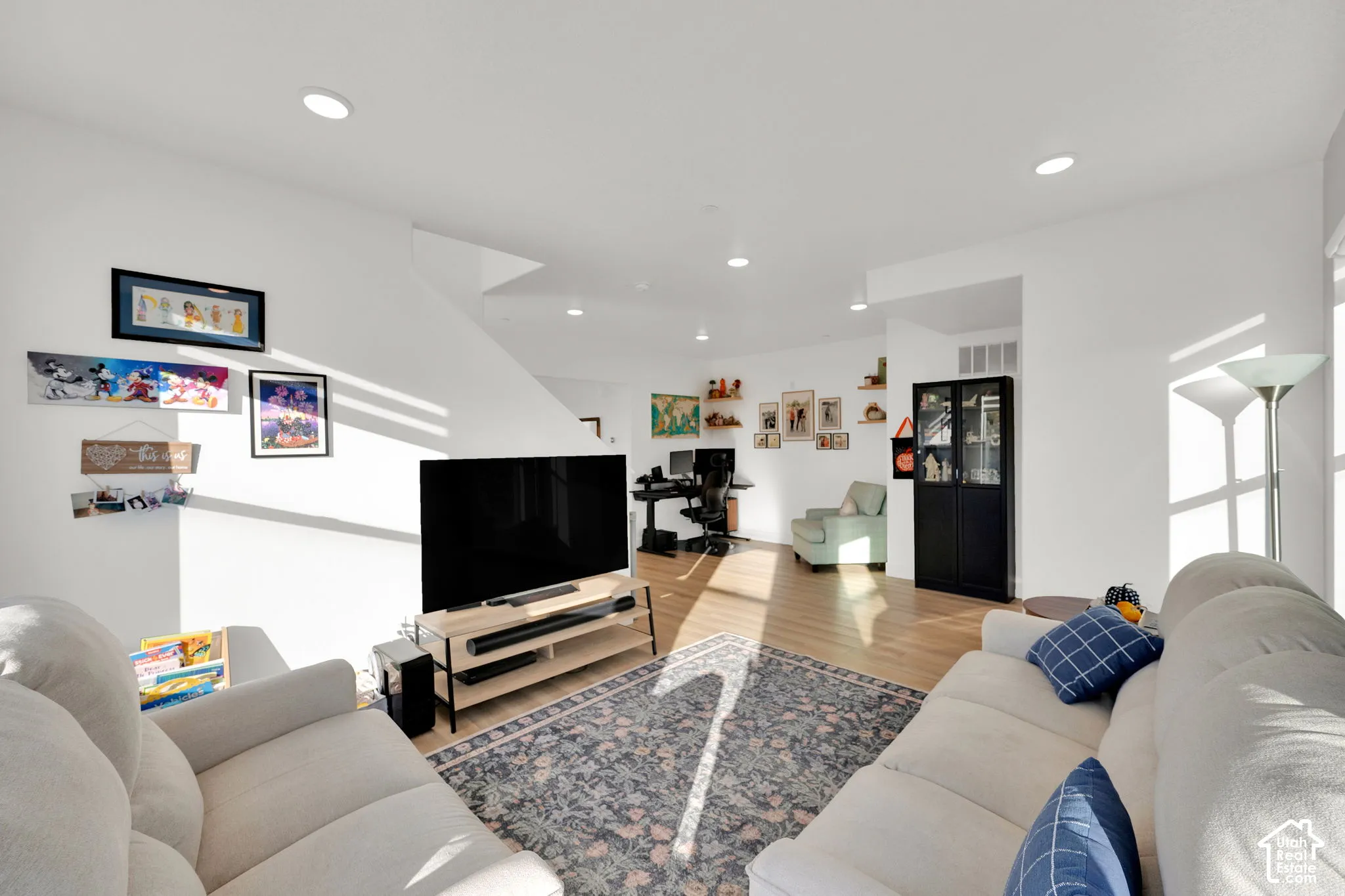 Open-concept interior featuring recessed lighting and wood-finish flooring