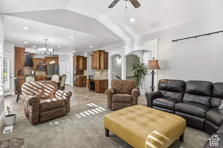 Vaulted ceilings, built-in cabinetry, recessed lighting, tile flooring, and arched architectural detailing