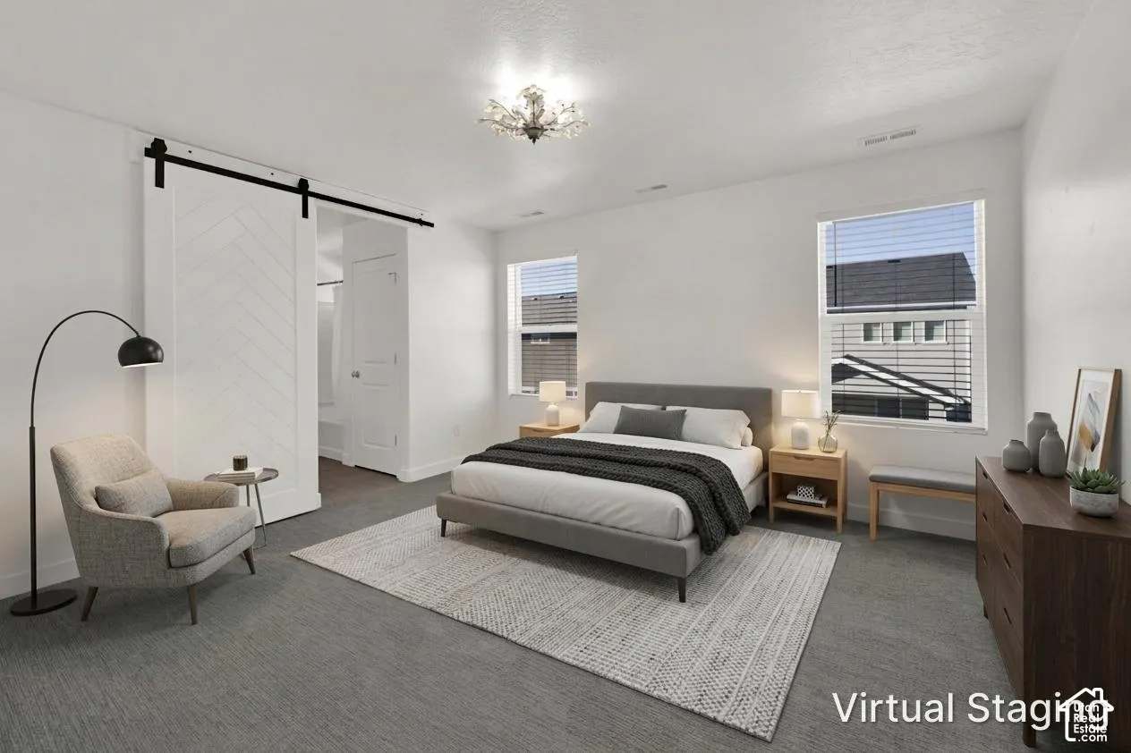 Interior space featuring a white herringbone-pattern sliding barn door, wall-to-wall carpeting, and a multi-light flush-mount fixture