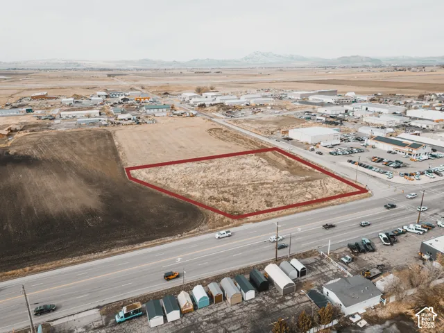 Expansive undeveloped parcel featuring prominent road frontage and mountain surroundings