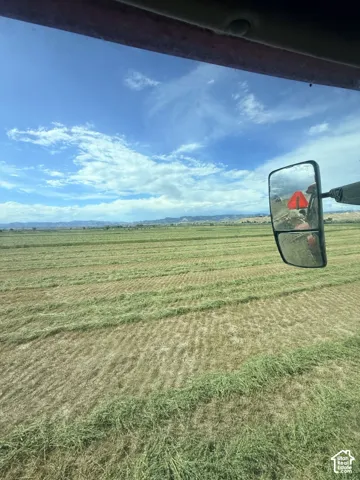 Expansive acreage featuring harvested agricultural land and distant mountain terrain