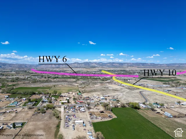 Aerial perspective of expansive land featuring mountainous terrain, open acreage, and proximity to major regional thoroughfares