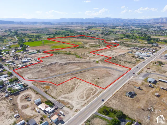 Expansive acreage featuring paved roadway access and prominent mountain backdrop