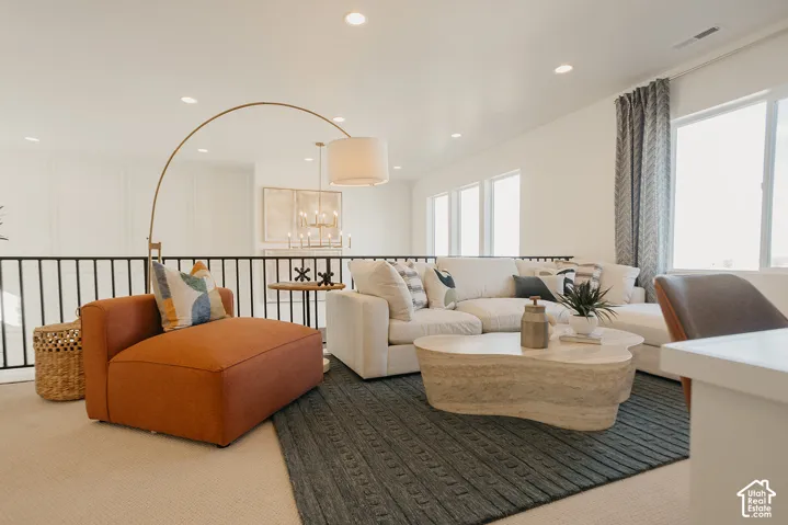 Open-concept room featuring recessed lighting, a matte black metal railing, and expansive windows