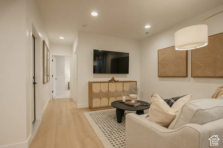 Recessed ceiling lighting, wood-finish flooring, and wall-mounted television installation