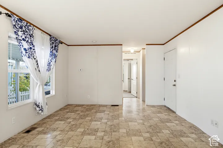 Interior space featuring multi-tonal tile flooring, neutral wall finishes, and trim detailing