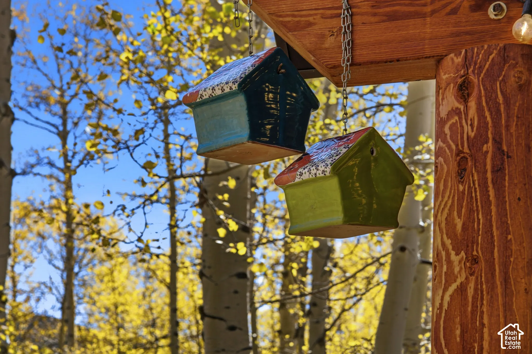 Natural timber support post featuring a rustic wood-grain finish and metal chain accents