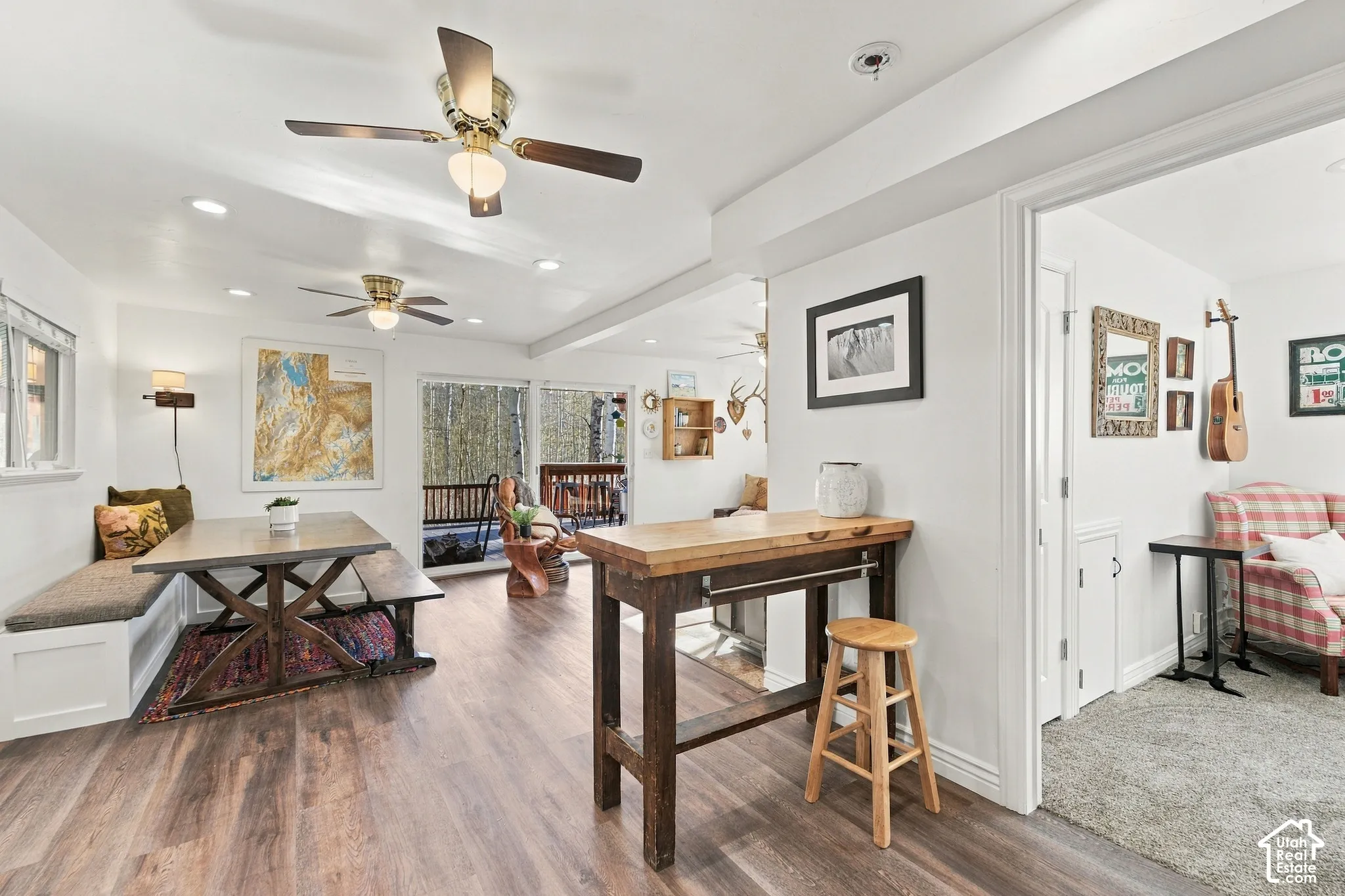 Wood-finish flooring, recessed lighting, ceiling fans, and built-in bench seating