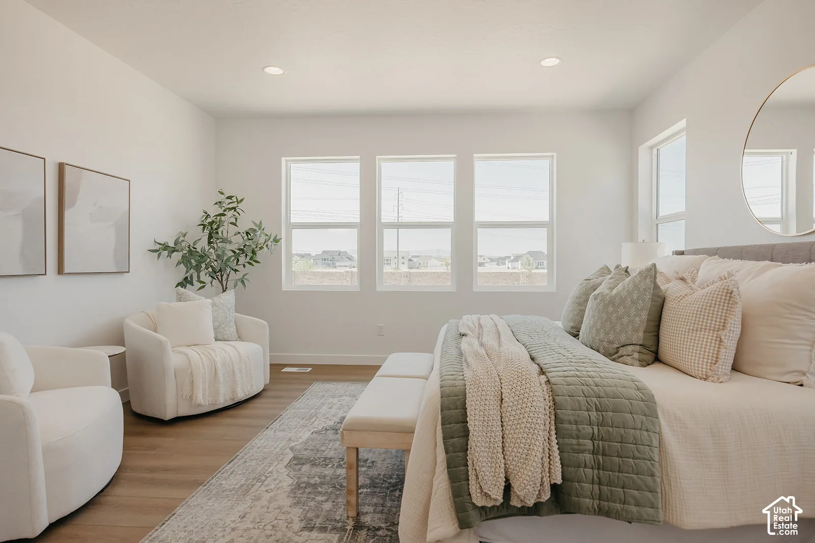 Bright room featuring wood-finish flooring, recessed lighting, and large windows with minimalist trim