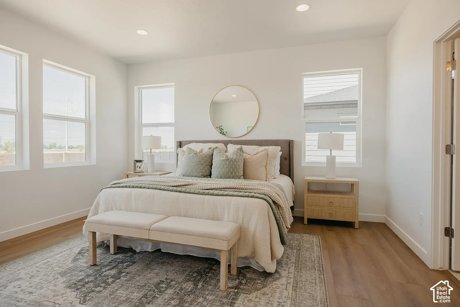 Neutral interior featuring wood-finish flooring, recessed lighting, and expansive windows