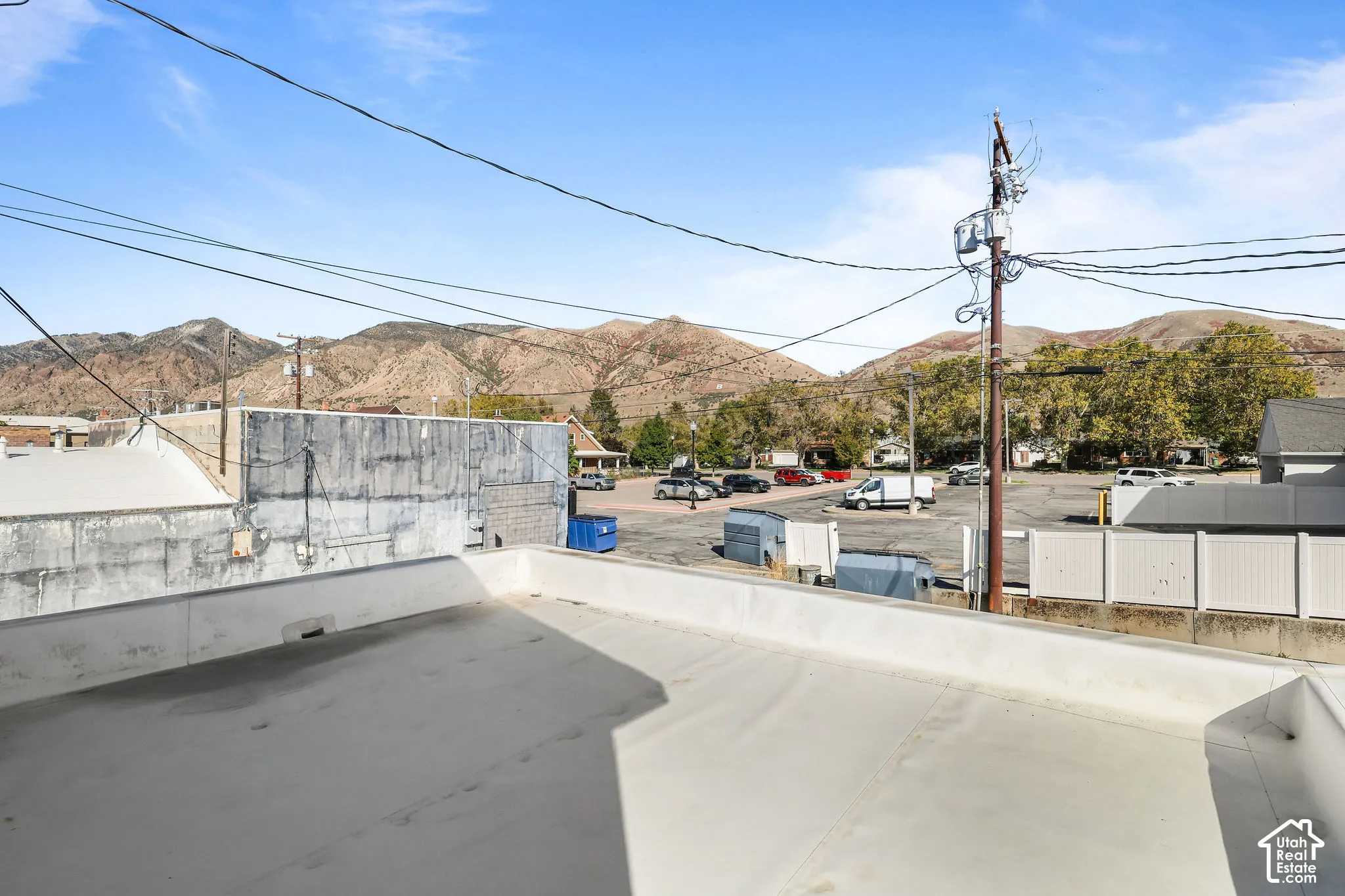 Flat roof terrace featuring concrete surfacing and a mountain backdrop
