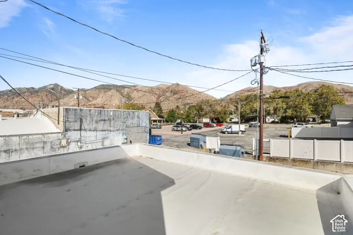 Flat roof terrace featuring concrete surfacing and a mountain backdrop
