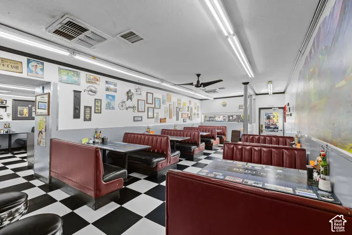 Checkerboard flooring, built-in booth seating, and ceiling-mounted light fixtures