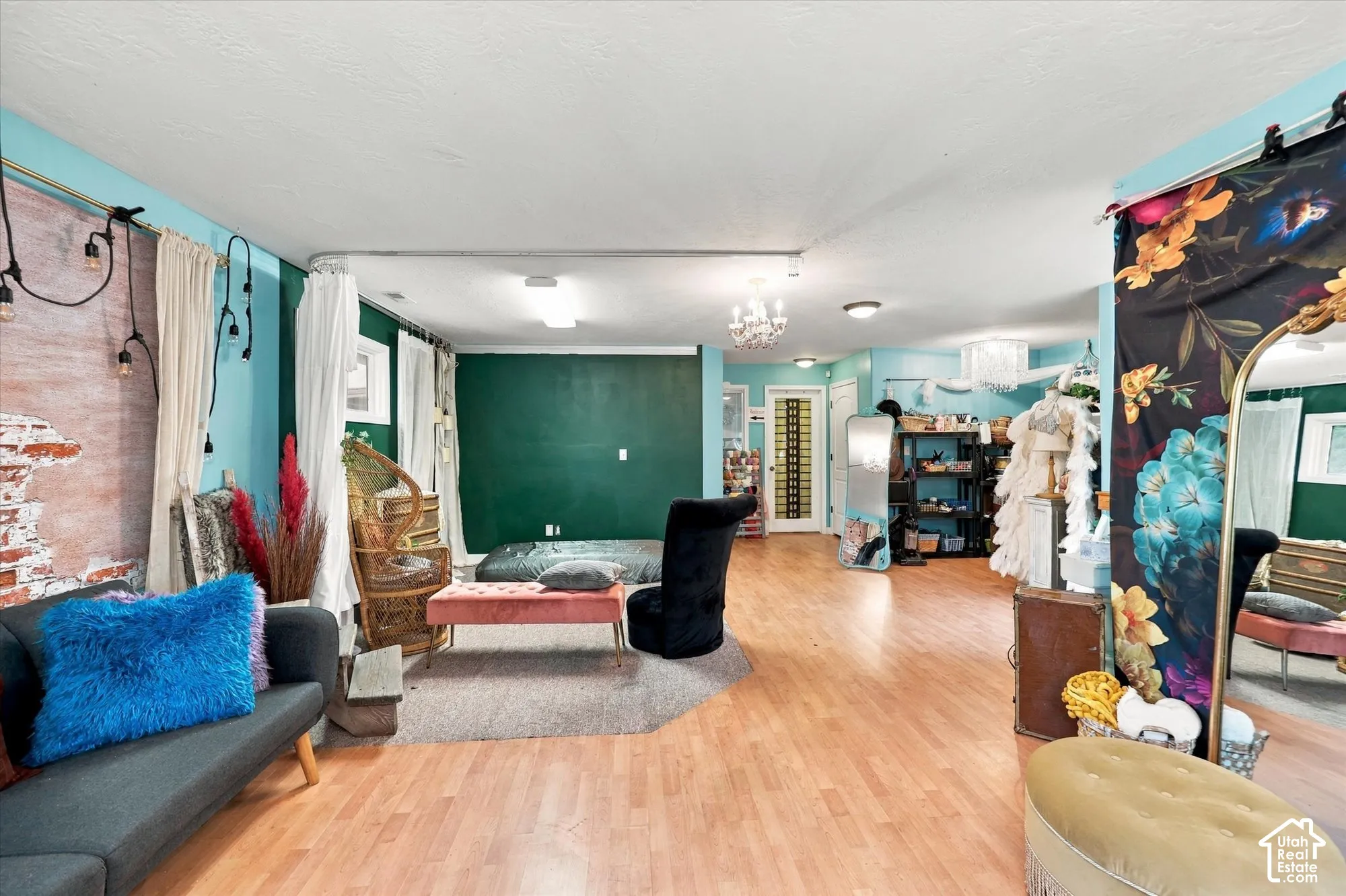 Open-concept interior featuring wood-finish flooring, recessed lighting, and a decorative glass-panel exterior door
