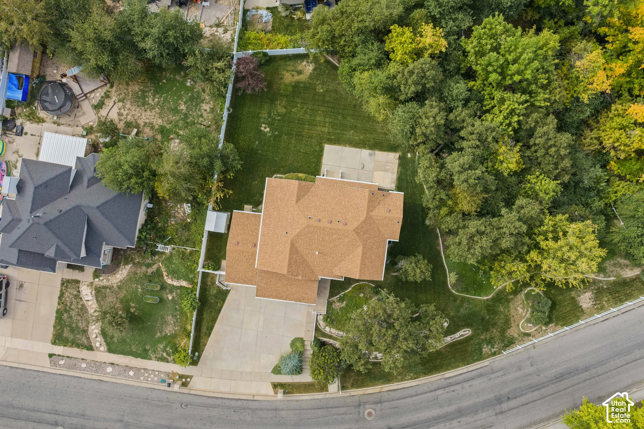 Aerial view featuring an expansive rear lawn, and mature trees