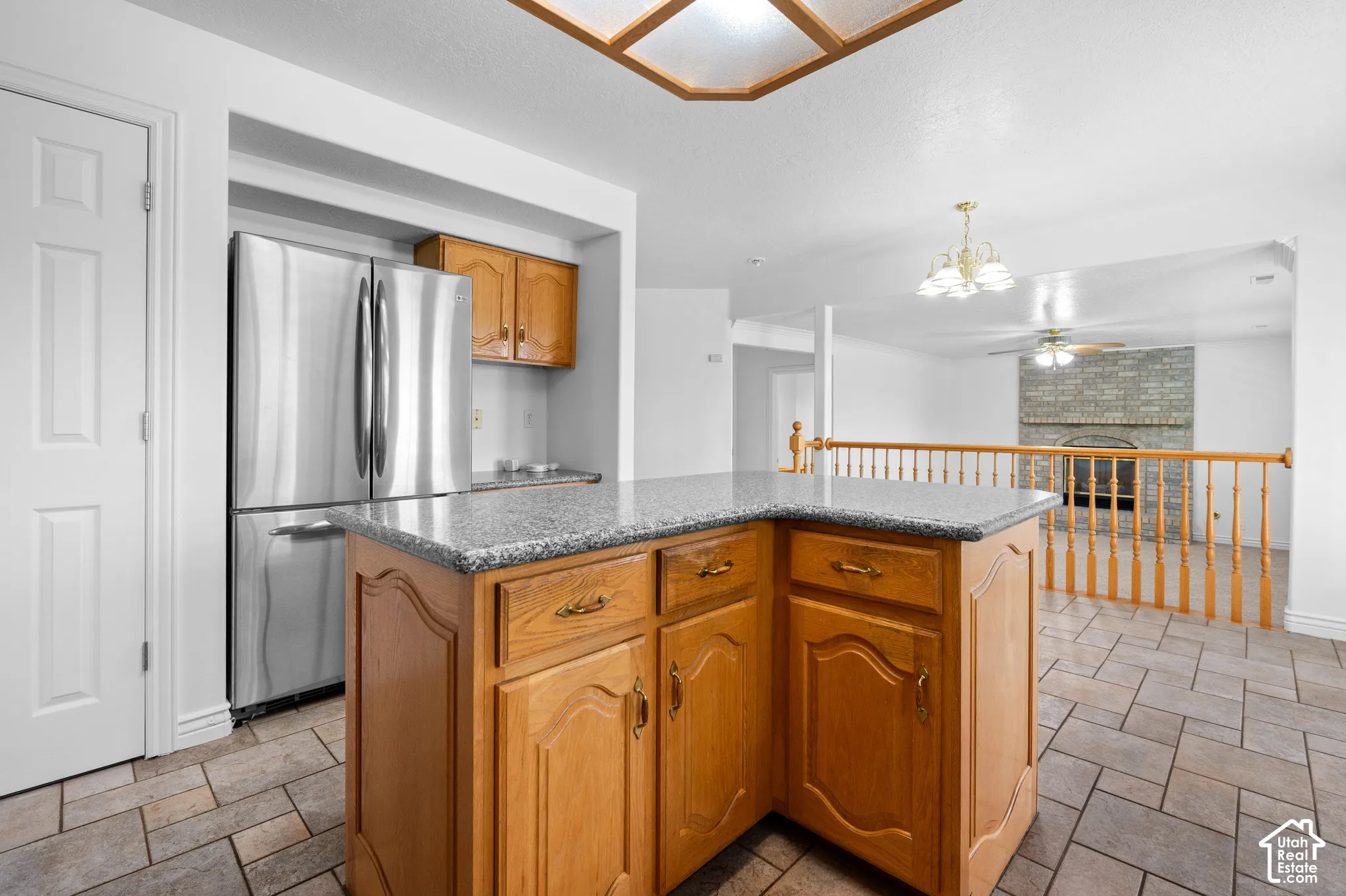 Kitchen island featuring cabinetry with raised-panel doors, and granite countertop,