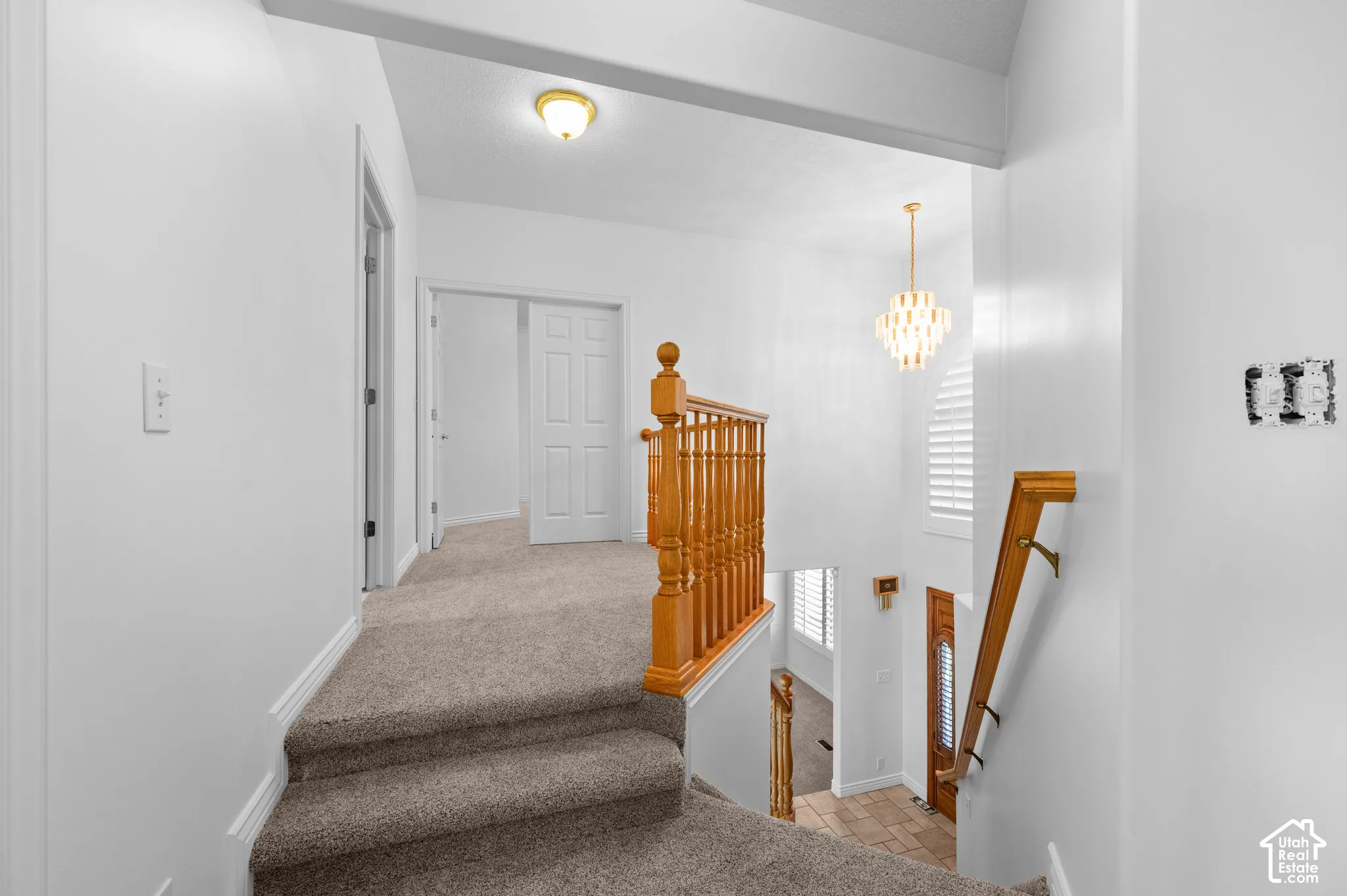 Upstairs carpeted landing looking into the primary bedroom